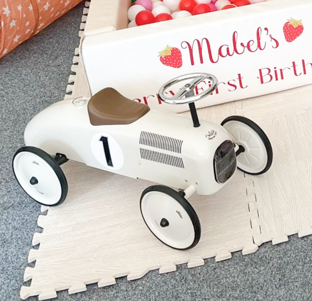 a child's ride on vintage style car