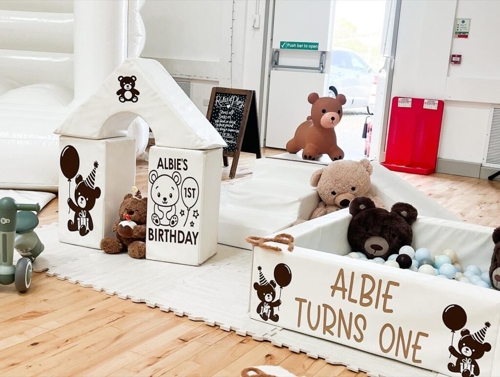Decorative bear and text stickers reading "Albie turns one" applied to the side of the ball pit and play blocks.