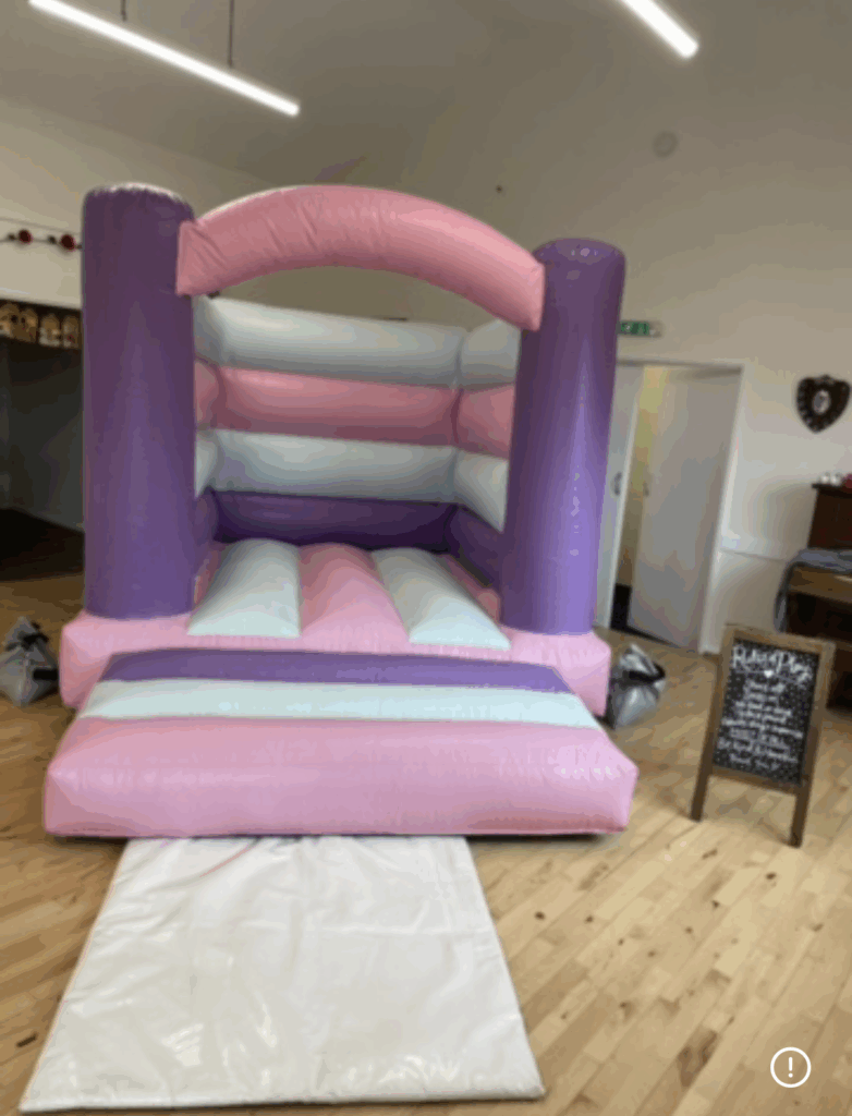 a bouncy castle in colours white, pastel pink and purple